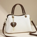 Elegant cream leather tote bag with brown handles and a heart-shaped charm accessory - White