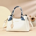 Elegant white pebbled leather tote bag with floral silk scarf handle and gold leaf pendant - Off White