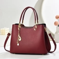 Classic burgundy lychee pattern handbag with golden musical note pendant and top handles - Burgundy