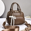 Detail of coffee brown PU leather bag with pearl bow charm and jacquard shoulder strap - Coffee