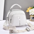 White faux crocodile leather handbag with wide woven strap and V-shaped tassel detail - White