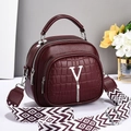 Elegant wine red handbag with crocodile embossing, V-logo and geometric strap - Burgundy