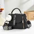 Black macaron tote bag with geometric texture, gold hardware and plush ball charm - Black