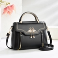 Classic black crossbody bag with golden flamingo heart charm and pearl tassel detail - Black