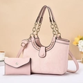 Pink embossed crocodile pattern tote bag set with chain handle in a modern lifestyle setting - Pink
