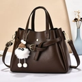 Dark brown leather handbag with bow charm and adjustable strap for women in high quality - Coffee
