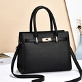 Minimalist black pebble grain leather handbag with gold metal clasp and cross body strap - Lychee Texture / Black