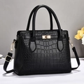 Elegante borsa nera con trama a coccodrillo, chiusura dorata e tracolla regolabile - Nero
