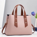 Detailed macro view of pink litchi grain leather texture and brown handle on handbag - 31*13*23CM / Pink