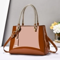 Brown patent leather handbag for women with gold woven handles and adjustable crossbody strap - Earthy Yellow