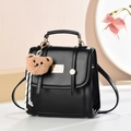 Minimalist black faux leather backpack for women with a cute brown bear charm and gold zippers - Solid Color / Black