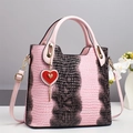 Detail of pink and brown crocodile texture handbag with heart charm and gold hardware - Pink (With Heart Charm)