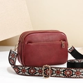 Burgundy faux leather crossbody bag with three zip compartments and patterned strap - Burgundy