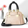 Detail of elegant crocodile-patterned shell bag with a crystal clasp and pink tulips - Apricot