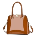 Detail view of brown patent leather handbag with dual gold zippers and metallic strap hooks - Earthy Yellow