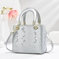 Elegant silver snake-pattern square handbag with gold hardware and adjustable strap - Silver
