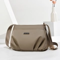 Minimalist khaki nylon shoulder bag with adjustable strap on a modern white display base - 26x10x19CM / Khaki (Small)