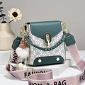 Detail of vintage patterned crossbody bag with wide strap and cute plush charm - Green