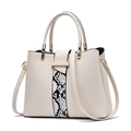 Off-white leather handbag with snakeskin pattern and gold hardware on white background - White