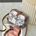 Detail of three-layer zip crossbody bag with paisley print and brown leather trim - Brown