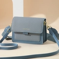 Blue canvas textured crossbody bag with wide strap and golden hardware accents - Blue