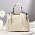 Elegant ivory faux leather handbag with lychee texture and detachable shoulder strap - White