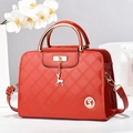 Chic red patent leather handbag with quilted patterns and a golden deer pendant charm - Burgundy