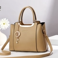 Khaki pebbled leather handbag with fashion lettering and celestial charm accessory - Khaki