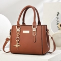 Caramel pebble leather handbag with gold star pendant and adjustable shoulder strap - Star Style/Earth Yellow