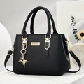 Elegant black lychee grain leather handbag with gold hardware and stylish star charm - Star Style/Black