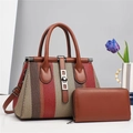 Striped woven handbag and matching brown leather wallet set on light grey background - Red