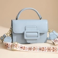 Elegant light blue PU leather handbag with wide floral embroidery strap on beige background - Blue