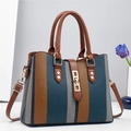 Detailed view of large canvas tote bag with tricolor stripes and premium metal lock - Blue
