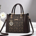 Brown monogram handbag with golden hardware, heart pendant and leather texture details - Coffee