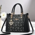 Elegant black leather handbag with monogram pattern and heart pendant for women - Black