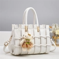 Close-up of white woven leather handbag featuring a plush bear charm and gold hardware - 28*14*18CM / Pure White