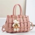 Pink woven leather tote bag with gold hardware and a cute bear charm on a white stand - 28*14*18CM / Pink