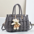Detail of grey woven leather handbag with gold hardware and cute plush bear charm - 28*14*18CM / Gray