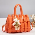 Detail of orange litchi grain leather tote with woven texture and teddy bear charm - 28*14*18CM / Orange