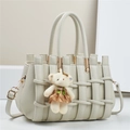 Detail of off-white tote bag with woven texture, gold hardware, and bear charm - 28*14*18CM / Off White