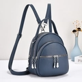 Macro detail of high-quality lychee texture on this blue multi-layer mini backpack - Blue