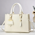 Detail of cream leather handbag with lychee texture and elegant gold-tone hardware accents - Off White