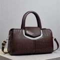Deep brown crossbody bag with crocodile texture and double handles on a grey stand - Coffee