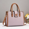Detail of lavender litchi pattern faux leather tote with brown handles and gold hardware - Purple