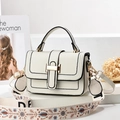 White leather handbag with wide embroidered strap and gold hardware on white pedestal - Off-white