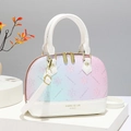 Elegant shell bag with macaron gradient print and gold hardware on white pedestal - White