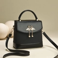 Black textured leather phone bag with golden swan clasp, pearls, and adjustable strap - Black
