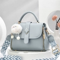 Fog blue lychee grain leather handbag with geometric strap and decorative puff ball - Blue