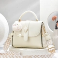 Creamy white litchi leather handbag with patterned wide strap and plush pendant - Off-white