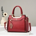 Elegant bright red crocodile embossed handbag with golden leaf charm and hardware - Burgundy